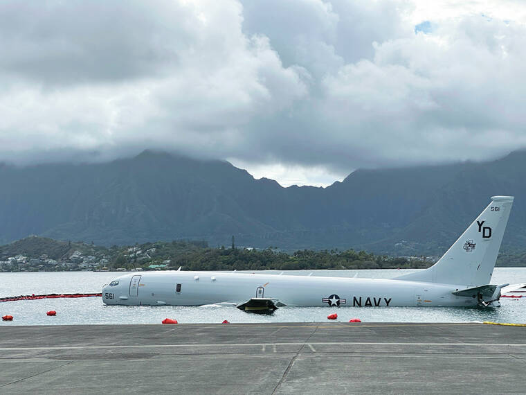U.S. Navy removes fuel from plane that overshot runway and is now resting on a reef and sand